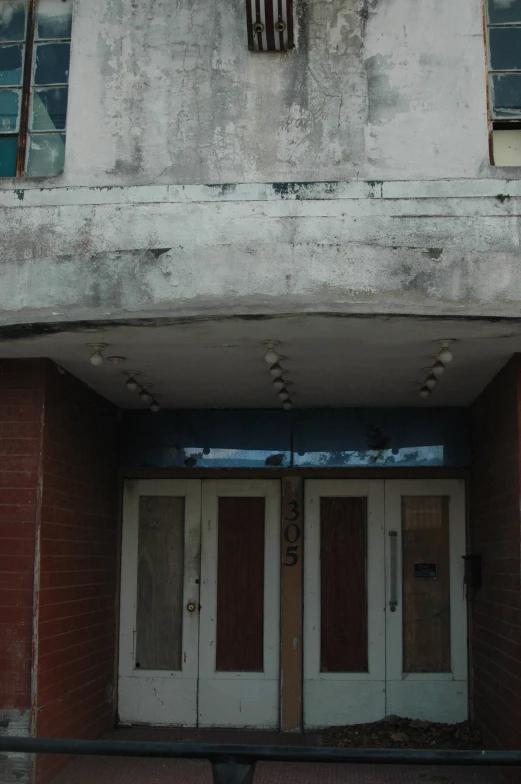 two white doors on the outside of a building