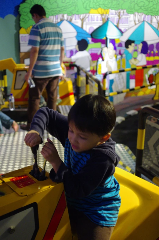 small child on toy car at a children's play park