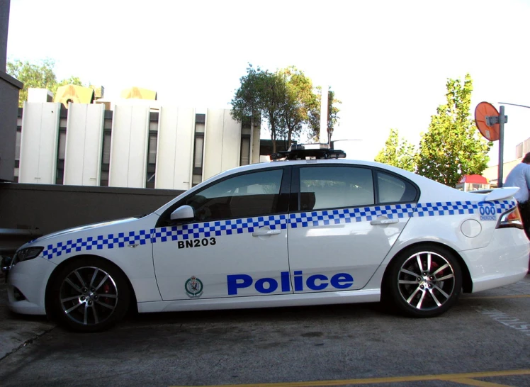 a police car parked next to a traffic cone