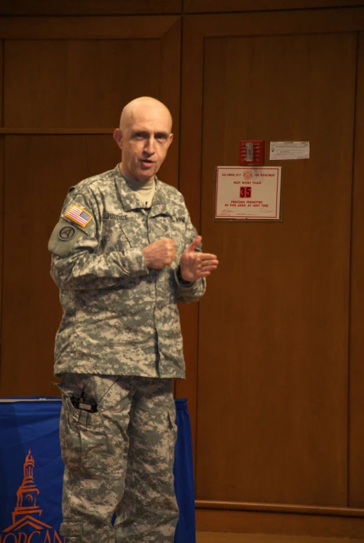 a man in military uniform holding his hands out