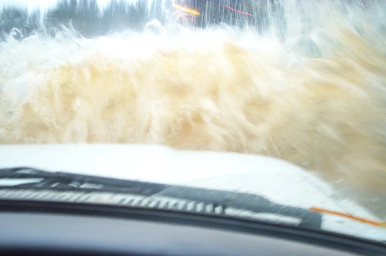 the view from behind the windshield of a car on a snowy road