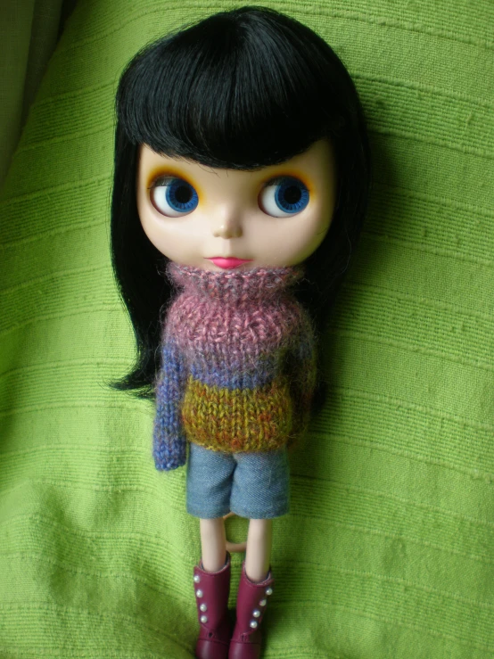 there is a doll with long hair and a sweater