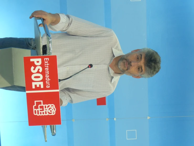 a man is standing in front of a large sign