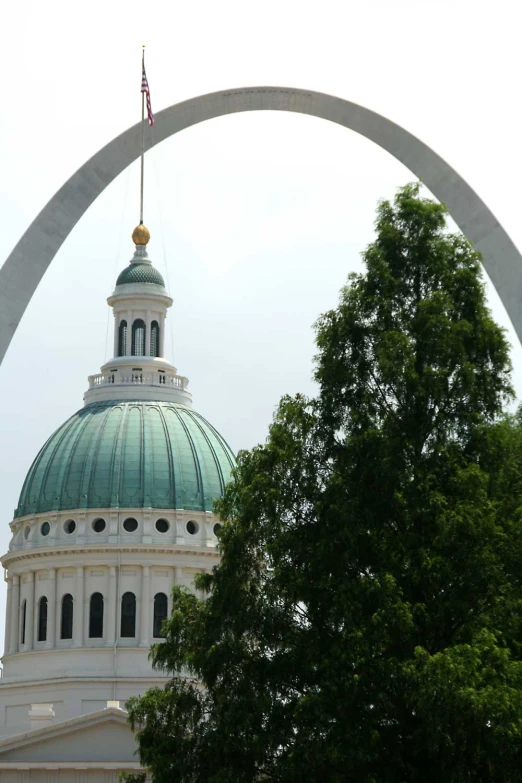 a white building with a green dome in the background