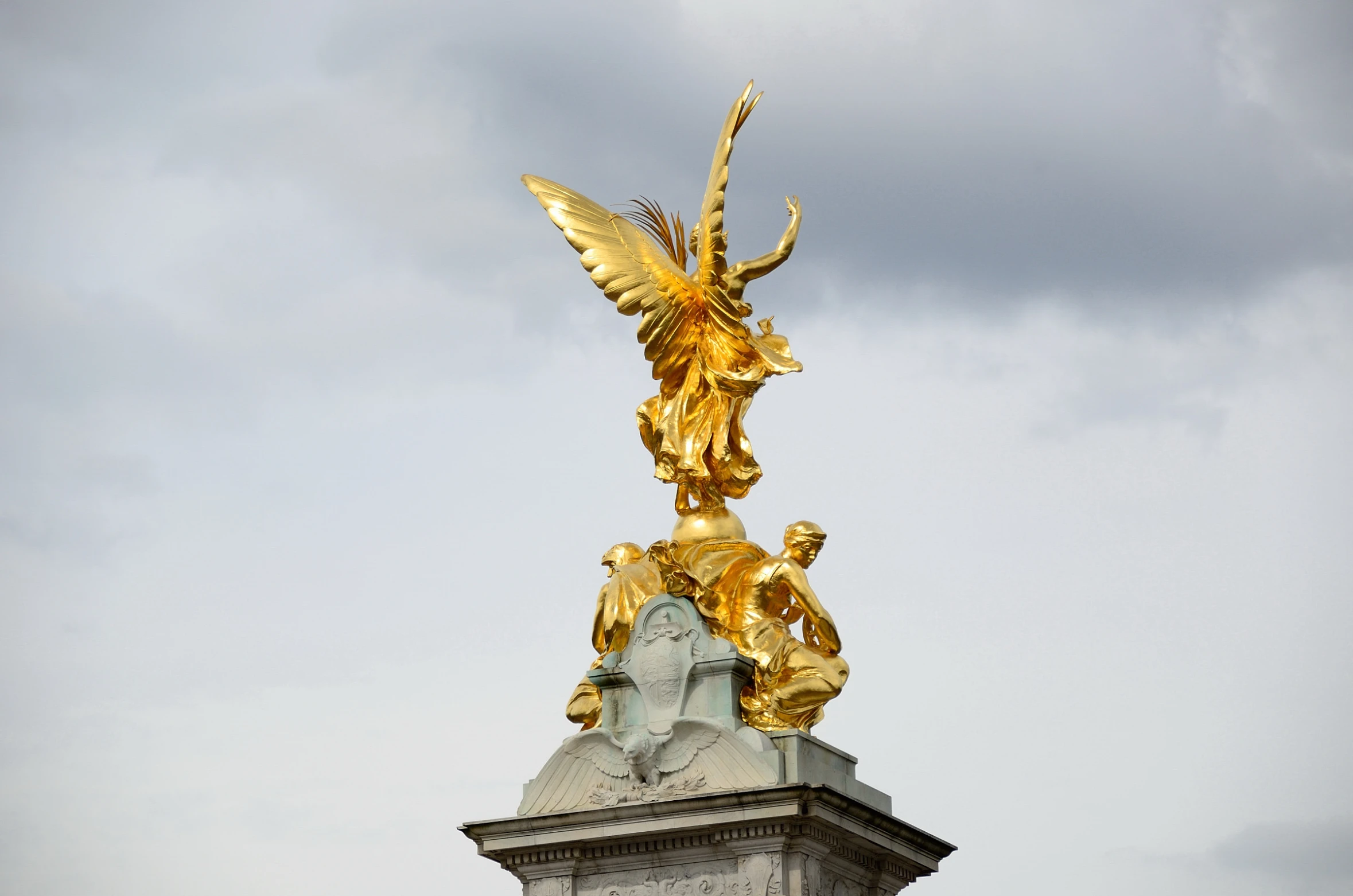 golden statue with two angels standing on top of it