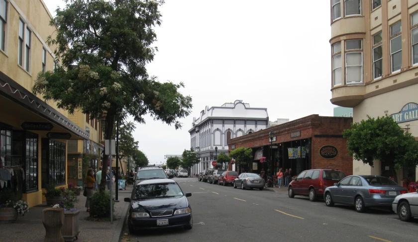 several cars parked along the side of an intersection