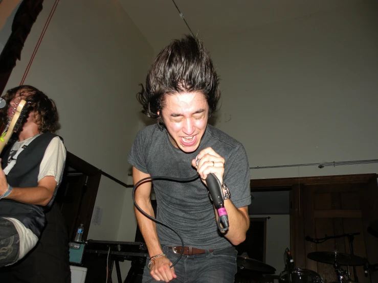 a man with an angry face holding a hair dryer