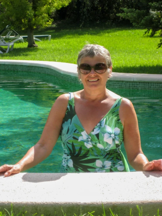 woman standing near pool with her arms on the edge