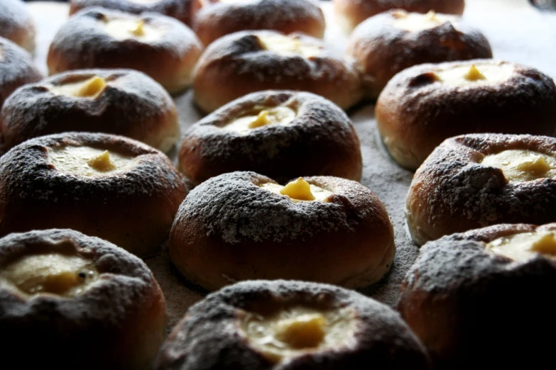 powdered sugared sugar rolls with bite taken out of one