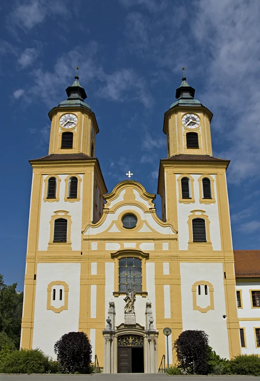 large white and yellow building with three towers