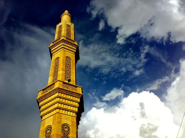 a clock tower in front of cloudy skies