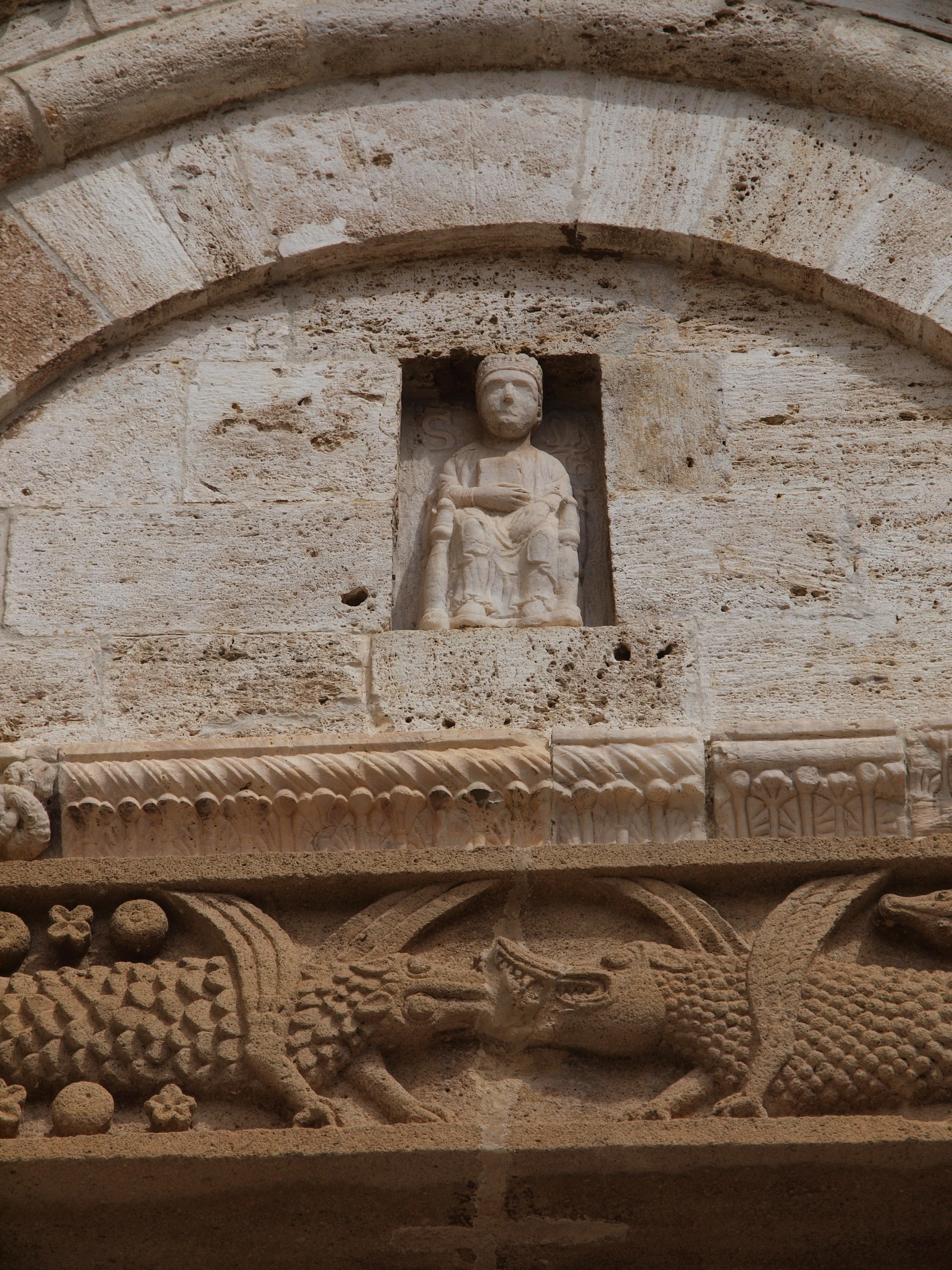 a decorative statue is in between an arched door