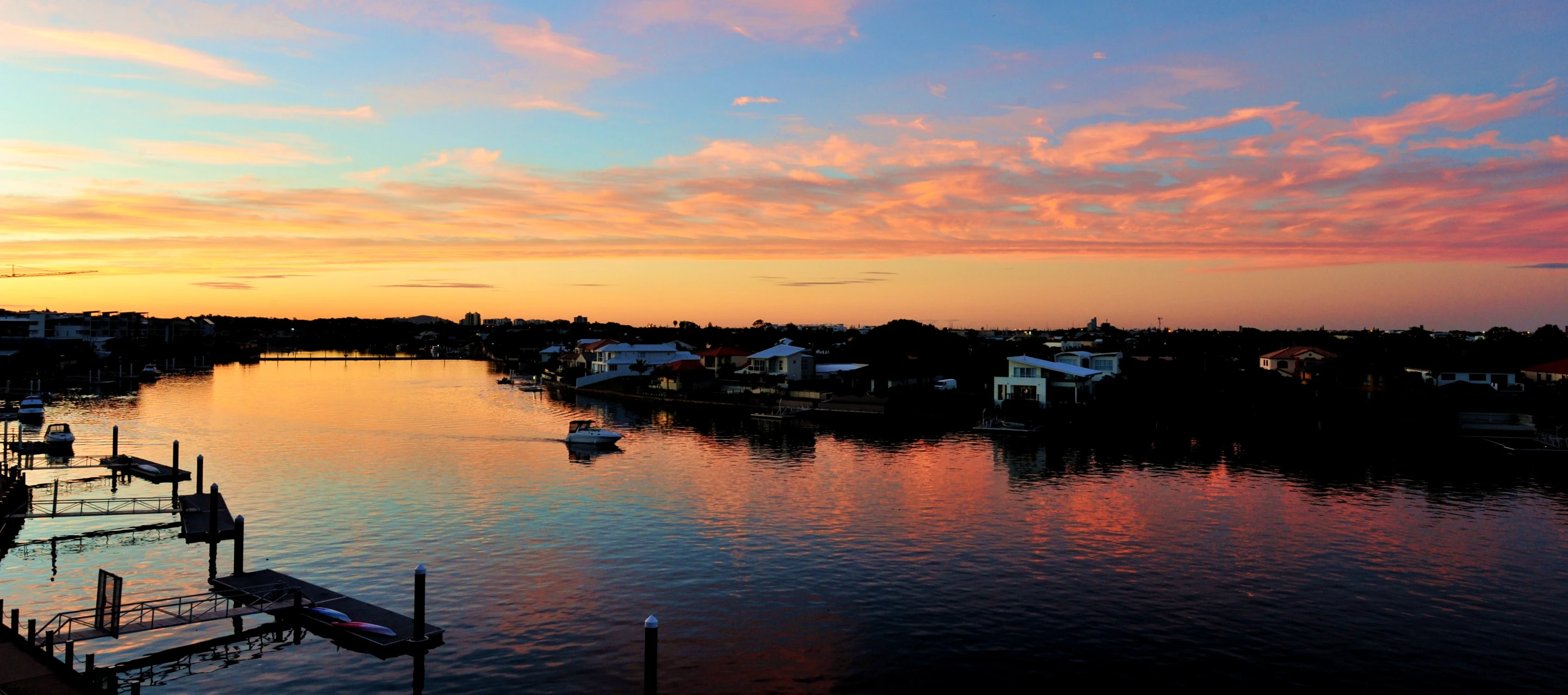 a harbor filled with boats under a blue sunset