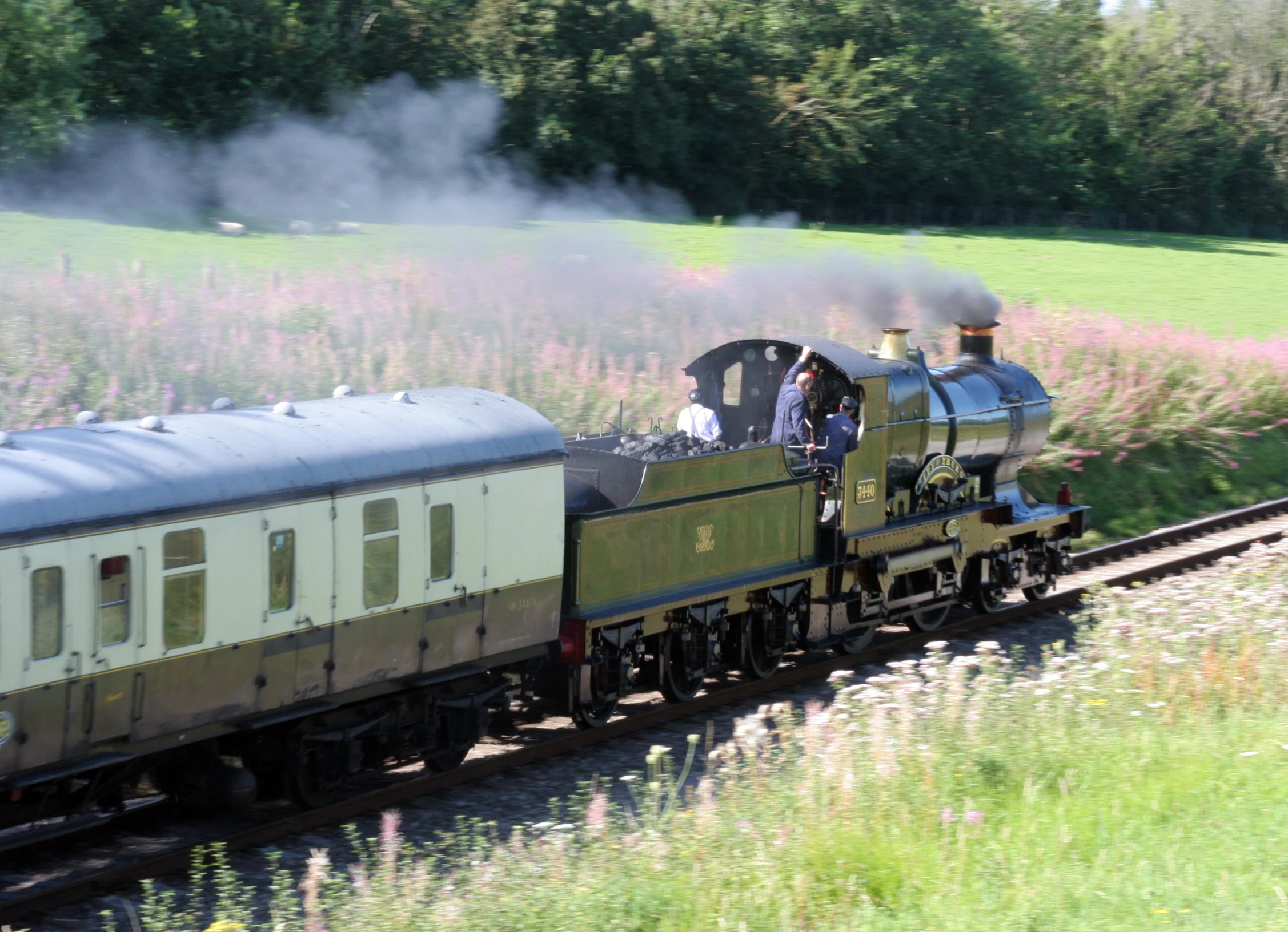 a train travels through the countryside on railroad tracks