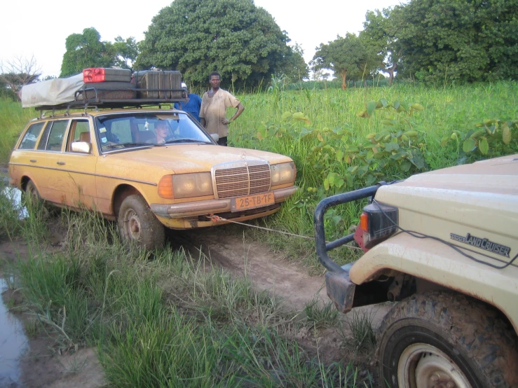 an abandoned station wagon parked in a field