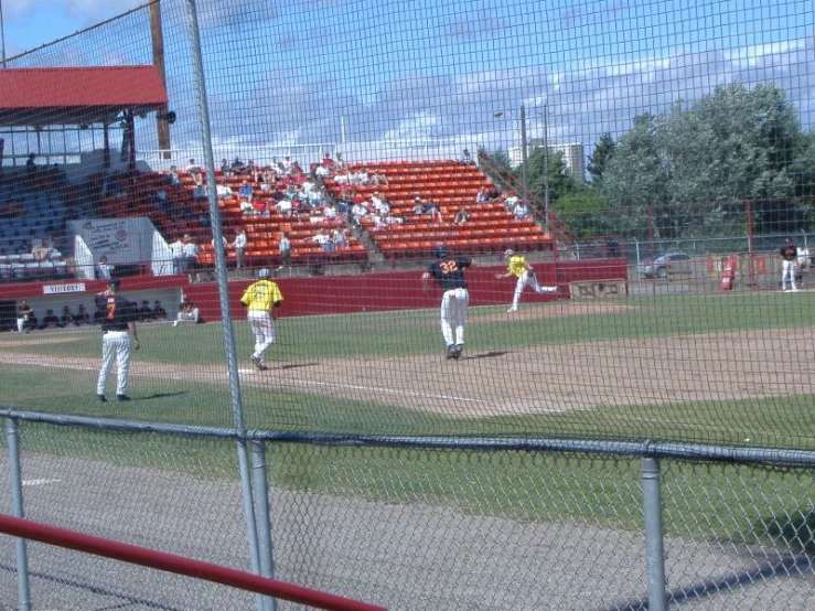 a baseball game in progress as the batter stands ready to hit the ball