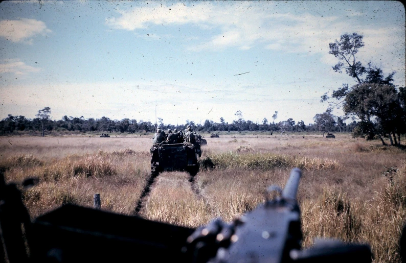 the military vehicle is sitting in a field