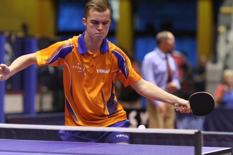 a table tennis player playing in a game of ping pong