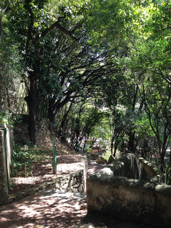 two rock structures sitting between trees on a path