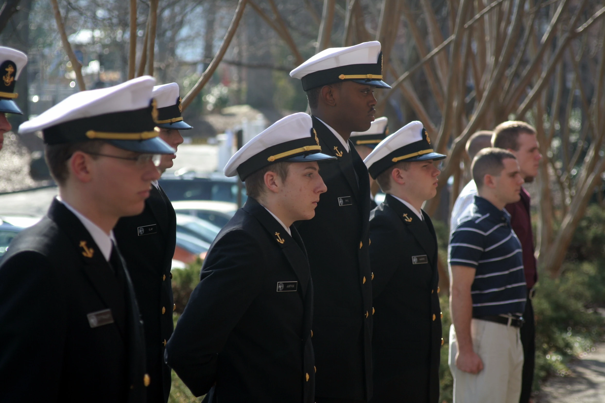 some people in uniform are standing outside