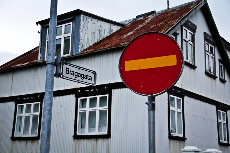 a big house with a sign near it