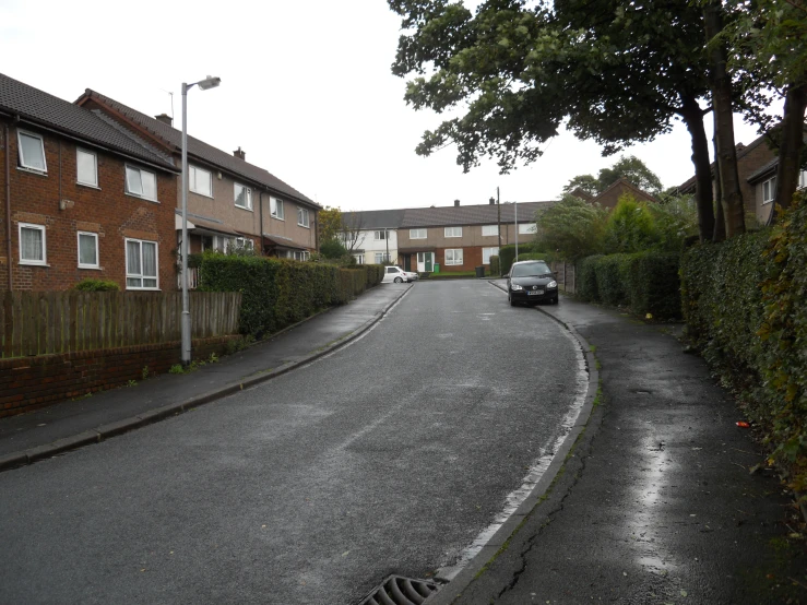 a street in the middle of houses that is completely empty