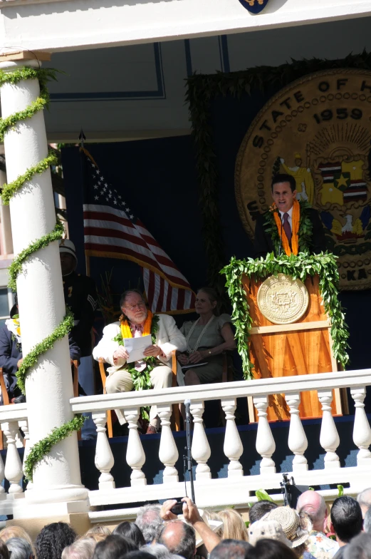 a man holding an object on a balcony