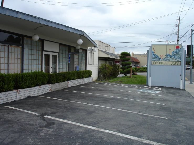 the parking lot in front of the building has only two cars