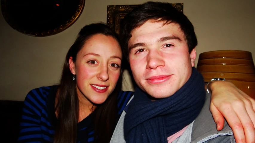 a man and woman pose for a selfie