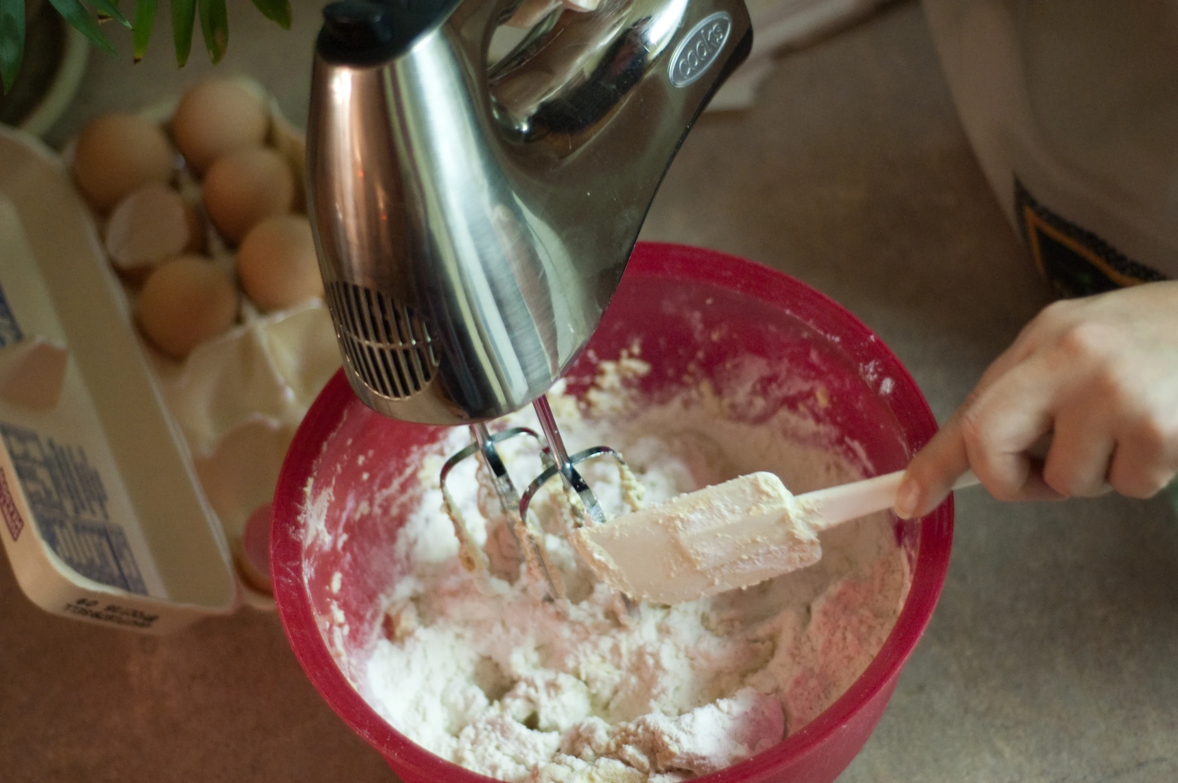 a mixing bowl with soing white inside it