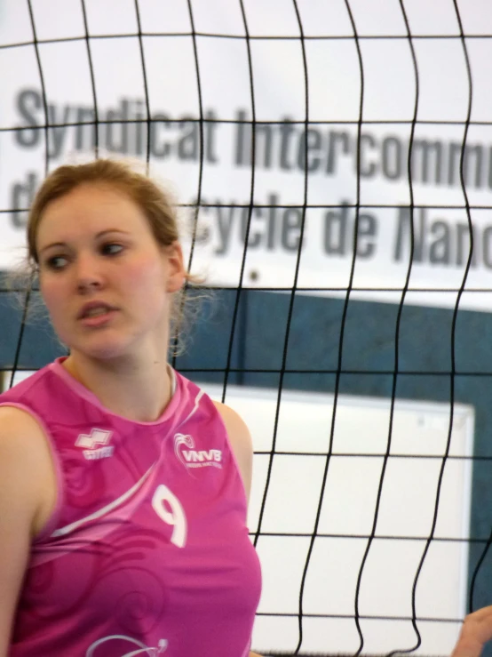 a young woman getting ready to hit a volley ball