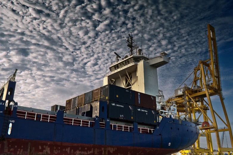 a ship in the water under cloudy skies