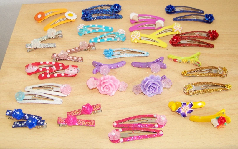 a wooden surface with small assortment of colorful clip hair clips