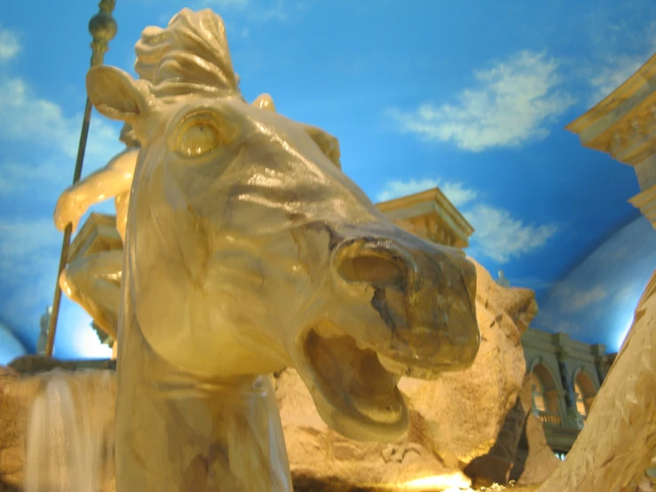 a marble statue with clouds on the sky in a building