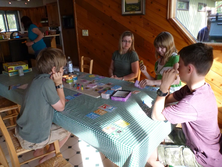 a group of people at a table playing games