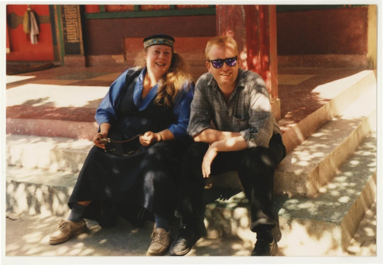 a man and a woman sitting on the ground near each other