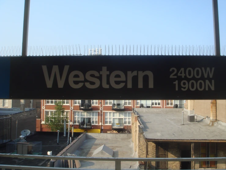 a black banner hanging from the side of a tall building