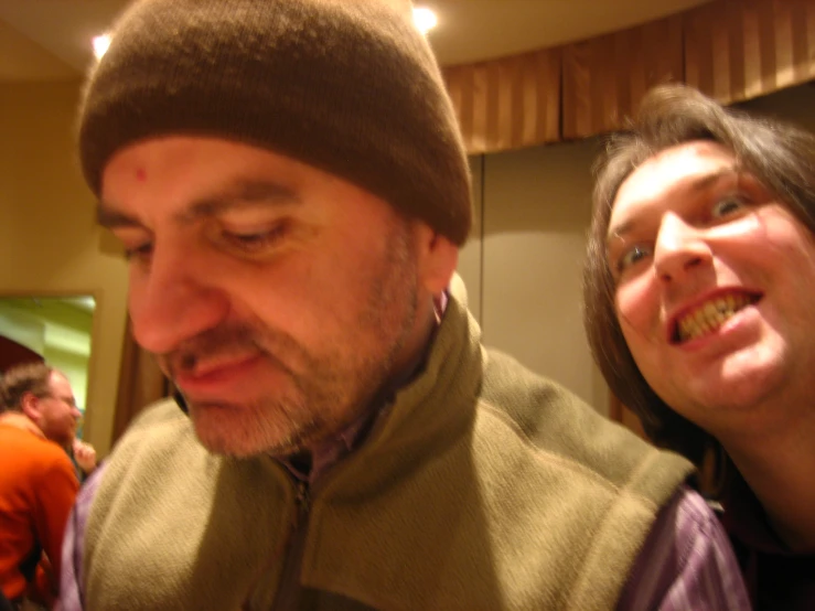 a man and woman smile as they eat food