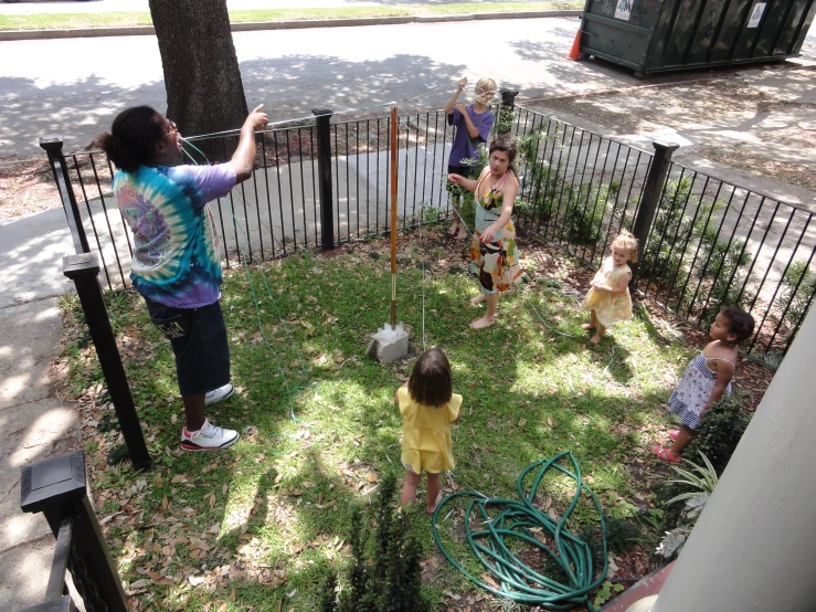 children playing with a large disc in the yard