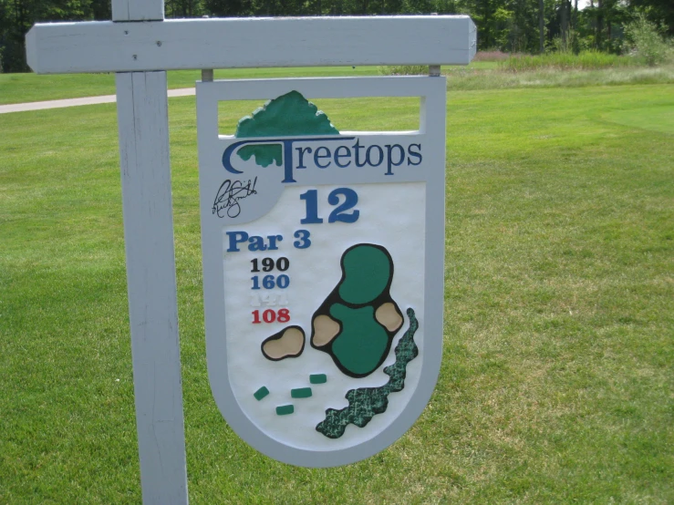 a sign outside with some trees in the background
