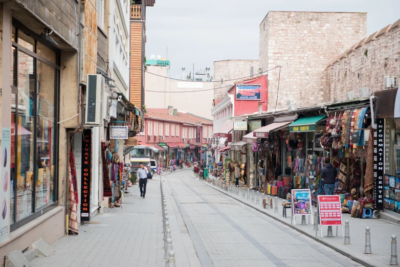 a road lined with shops and people walking