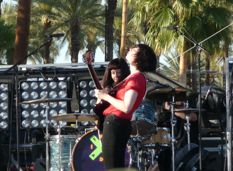 woman and man in front of instruments on stage