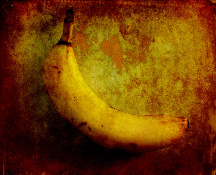 an aged banana hangs on a rusted old wall