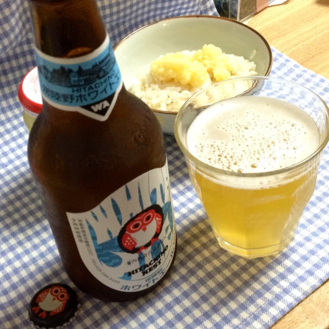 a bottle and bowl of food sitting on a table