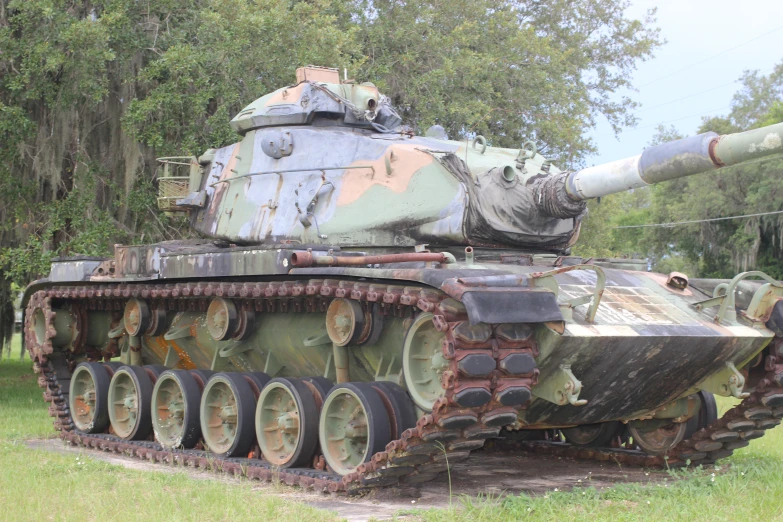 an old destroyed tank is being displayed