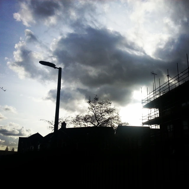 the sun is shining through some clouds near an area with buildings