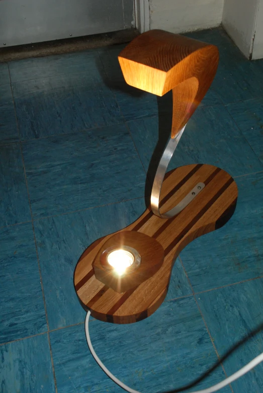 a wooden light sitting on top of a blue tiled floor
