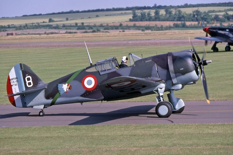 an air plane sitting on top of an airport runway