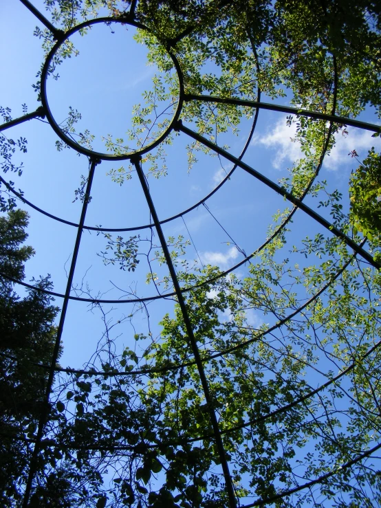the inside of an outdoor structure with the sky in the background