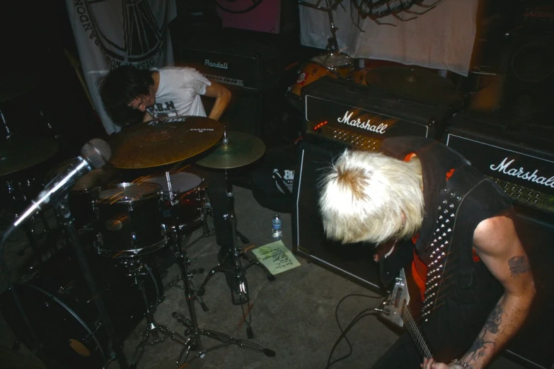 a man that is playing on some kind of guitar